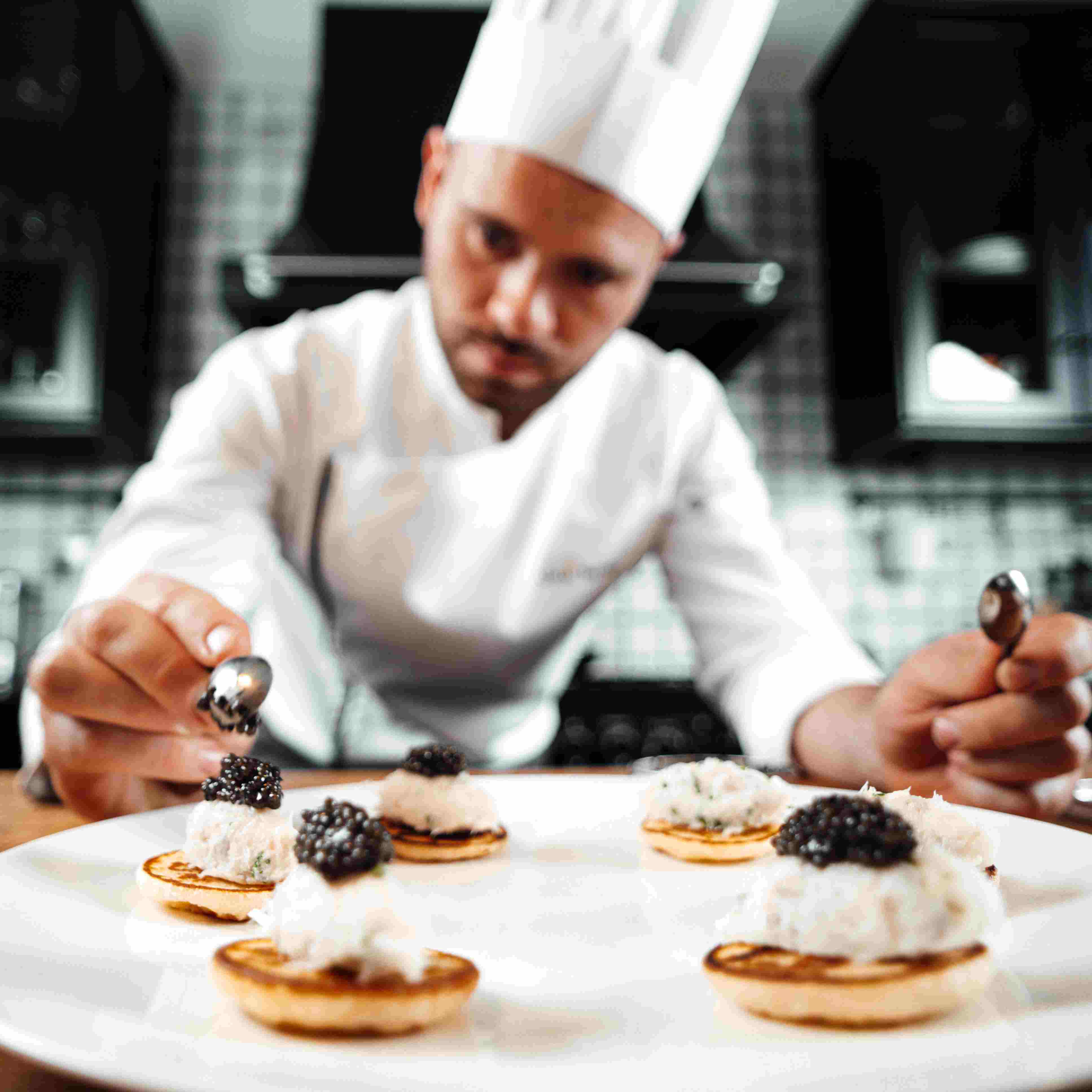 Chef Adam Brunet preparing a gastronomic dish